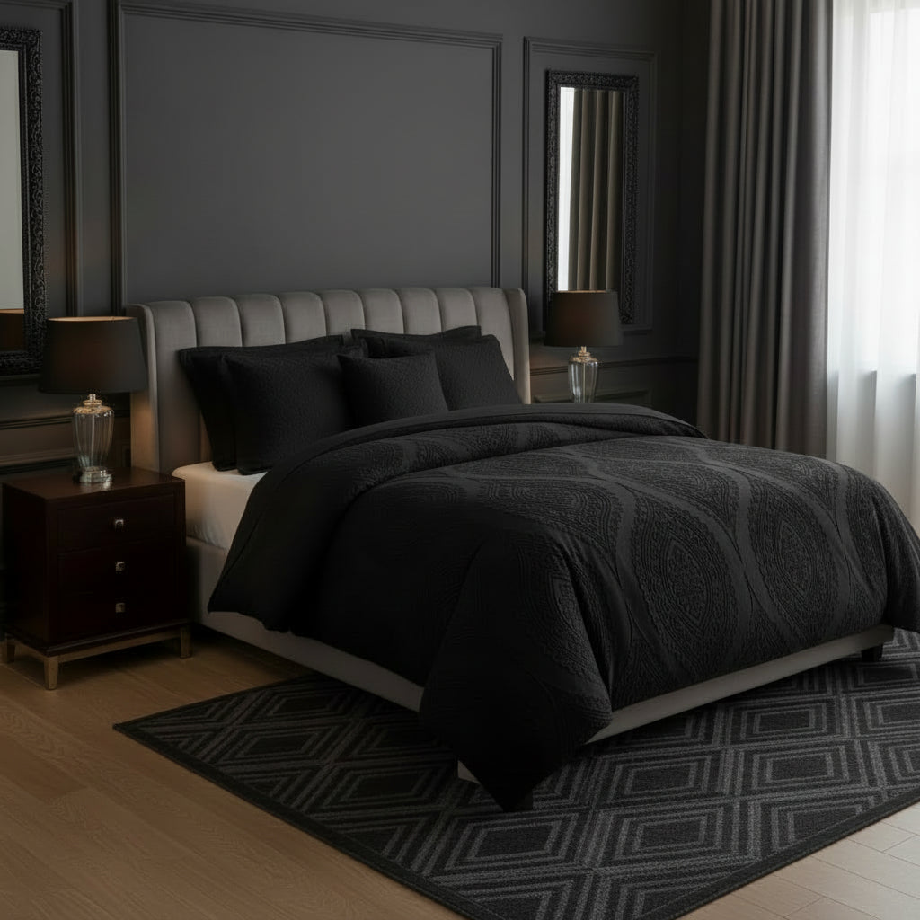 Dark-themed bedroom with a bed covered in black bedding and decor.